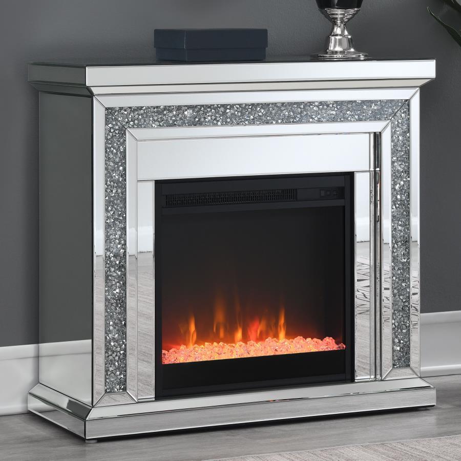 Glimmering, crushed crystals lend a luxurious accent to this glam fireplace. Covered by mirror tiles, trims and beveled edges, this freestanding electric fireplace offers a relaxing glow to a space. For a bit of warmth, turn on the heater element for a mo