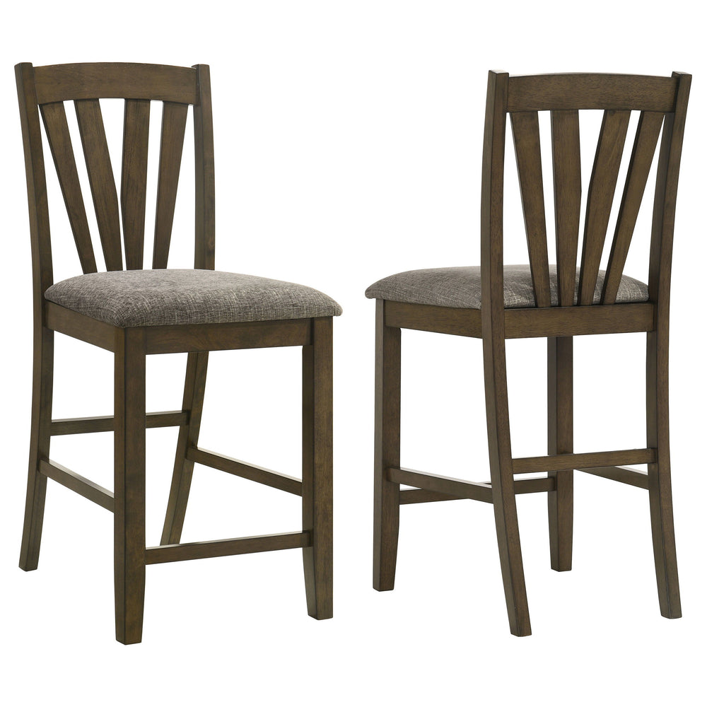 Complete your dining experience with this stylish and comfortable counter height dining chair. Crafted with a solid wood frame, this side chair offers sturdy support while the foam-padded seat cushions provide plush comfort. Upholstered in a grey fabric, 