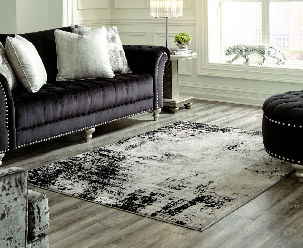 If you appreciate the art of subtlety, you-'re sure to be overjoyed with this area rug. Soothing shades of black, gray and cream form an intriguing abstract design that-'s sure to elevate your space with contemporary flair.<br/><br/><b>Product Features</b