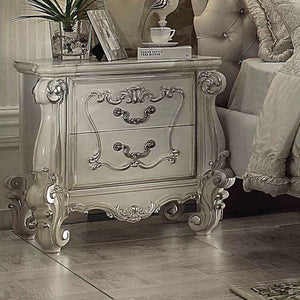 The Versailles nightstand is the perfect accent to create the style of royalty your bedroom has been needing. This nightstand crafted in wood with bone white finish was inspired by old European design with brown copper metal hardware and intricate wood ca