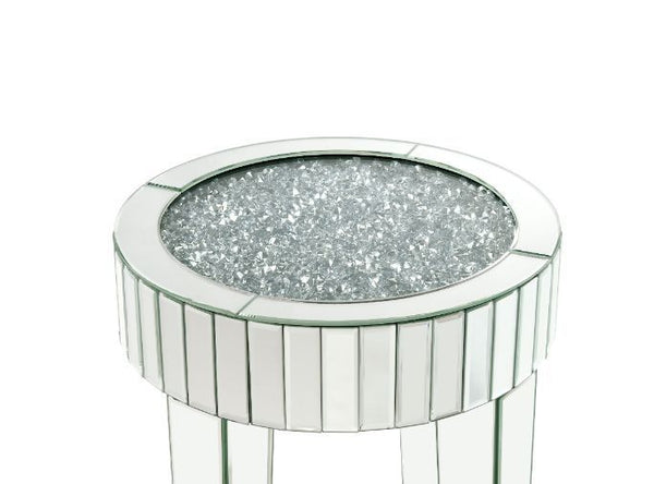  clean-lined silhouette accented by faux diamonds and mirrored finish. Adding depth and dimension to your room while upping the wow factor in your home. This Ornat End Table is ideal for displaying your precious family photos an