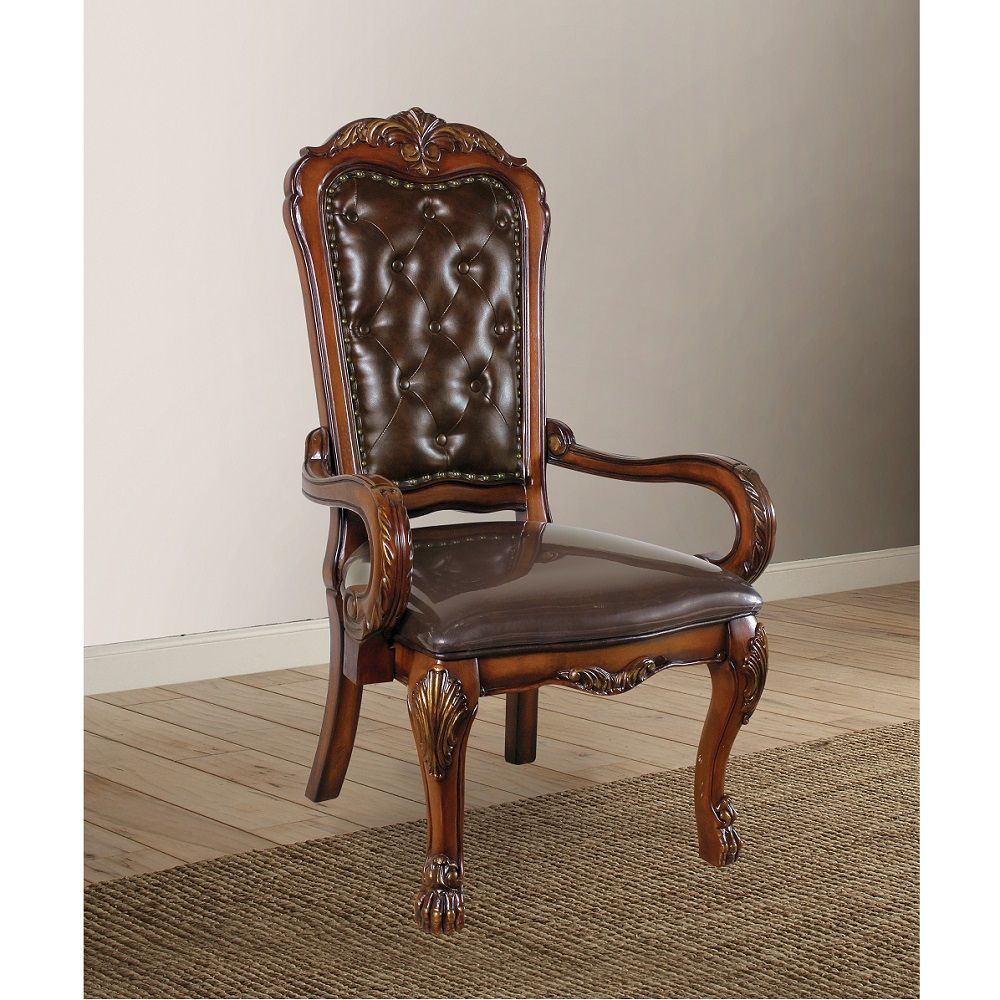 The Dresden executive arm chair classic style will blend masterfully in your home. Carefully constructed from faux leather selected wood and veneers in rich Cherry Oak Finish. Highly decorative details, button tufted backrest, claw feet and decorative Nai