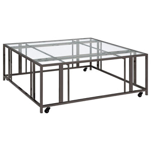 This square coffee table combines functionality with modern style, featuring a tempered glass top and a sturdy geometric base made from heavy-gauge metal. The open-frame design creates a sleek, contemporary look, while smooth-rolling casters add mobility 