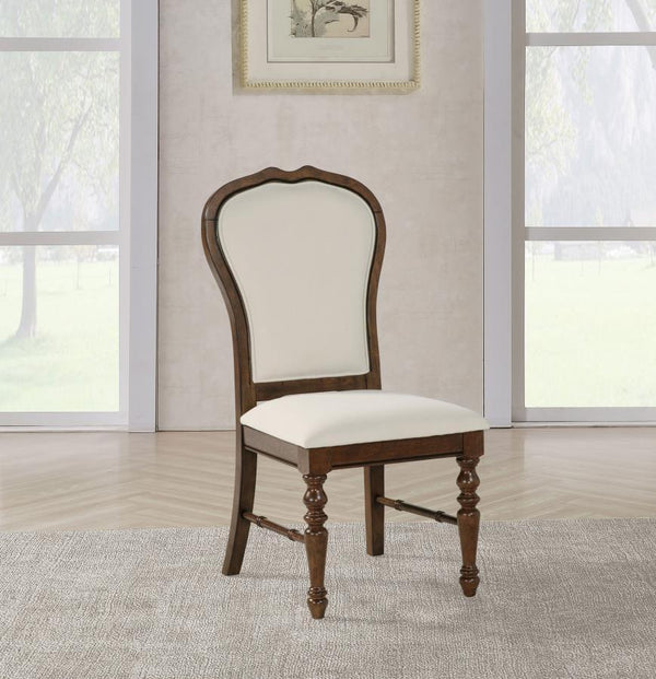  complete with a rich brown finish. Chairs are designed with decorative rounded backs