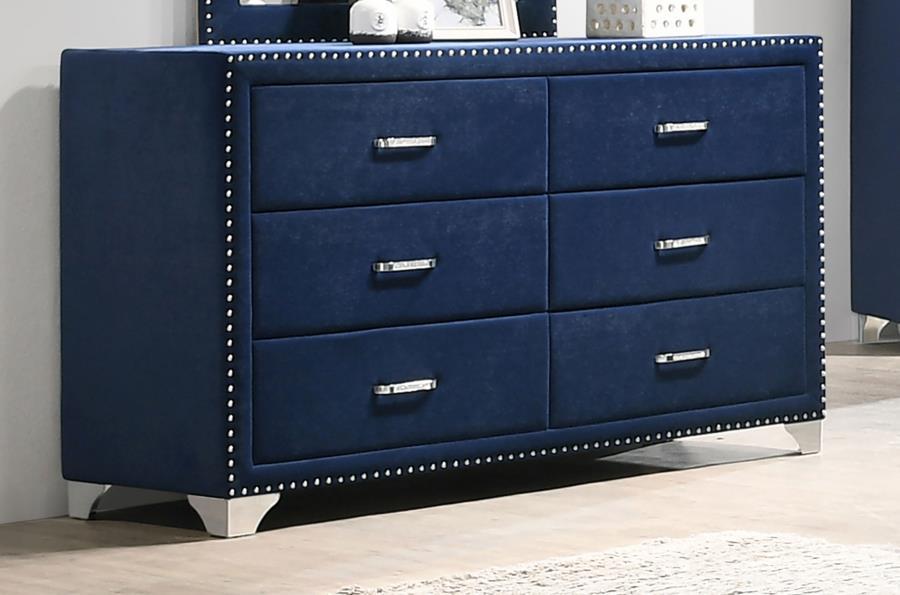 Give outdated sleeping spaces a facelift with this eye-popping and elegant dresser. Entirely upholstered in velvet, this dresser is a conversation starter. It is equipped with six spacious drawers to store your bedside items. Nail head trim makes a specta