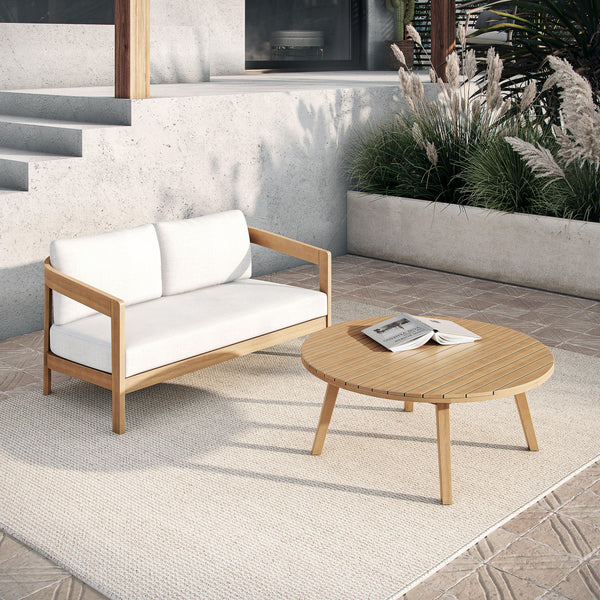  featuring a stylish outdoor loveseat with plush white cushions and a matching coffee table