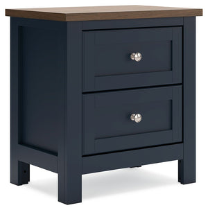 Add homespun charm to your restful retreat. A modern take on a timeless silhouette, this nightstand pairs a dark slate blue finish with a light brown top. Drawer fronts and legs in a classic Shaker style bring an air of beautiful simplicity to the bedroom