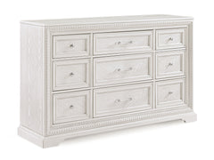Introducing a bedroom collection that brings a breath of fresh sophistication to any living space. This suite boasts a bright, antique white finish that immediately brightens and opens up a room, providing a versatile foundation for any decor style. The b