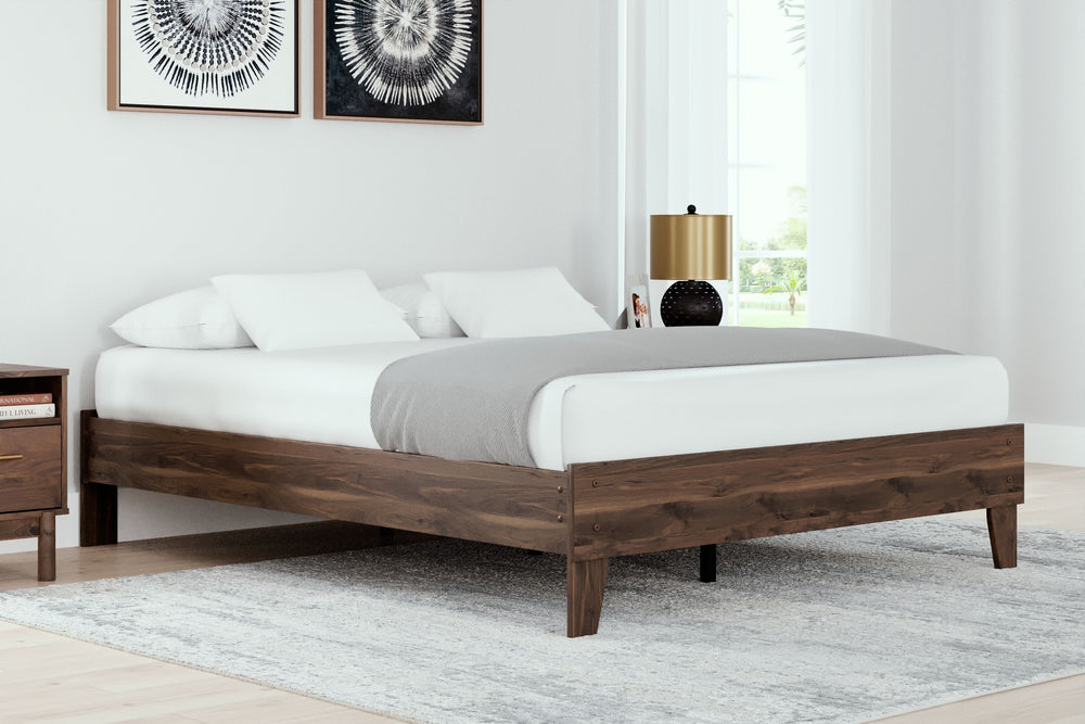 At the intersection of classic cool and chic sophistication youâ€™ll find this queen platform bed. The rich brown finish over replicated walnut wood grain offers an authentic touch that plays well any way you style it. Minimal yet elegant in its design, t