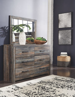 When merged in just the right way, rustic and industrial styles can make one happy marriage. Case in point: this dresser and mirror set. A refined take on barn board beauty, its complex, replicated wood grain showcases hints of burnt orange and teal tones