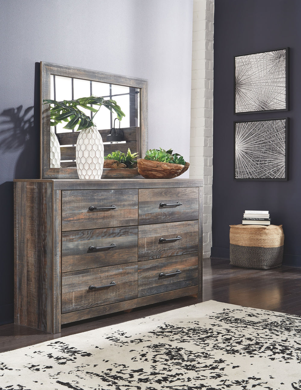 Burnt orange and teal colors accent a brown rustic finish in a replicated woodgrain with authentic touch. Large scaled dark colored handles. Cases feature a framed front and pilasters. All panel headboards (53,57,58,87) feature decorative matte black scon