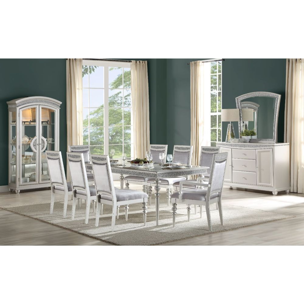 Make your dining room the centerpiece of your home with the Maverick dining set. This unique set comes in a platinum finish and sparkling rhinestone. The removable extension leaf which will create plenty of seating space and a welcoming place for all thos