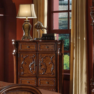 The Dresden Chest is crafted with the finest solid woods with veneers in cherry oak finish. Dresden Collection is enhanced by remarkable marquetry and generously carved wood elements. The case goods feature solid hardwood with five drawers and two door wi