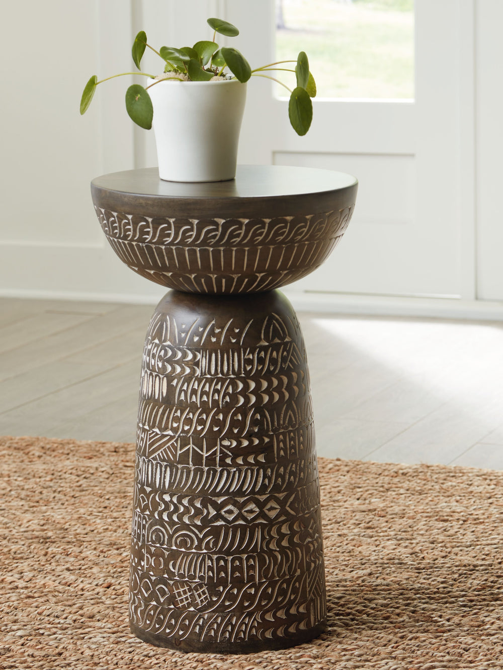 Part functional surface, part art form. Decorated with a carved floral design, this accent table adds an eclectic touch to your home furnishings. Stage it next to a sofa as a chic surface for remotes and drinks. Or use it as a display space for a potted p