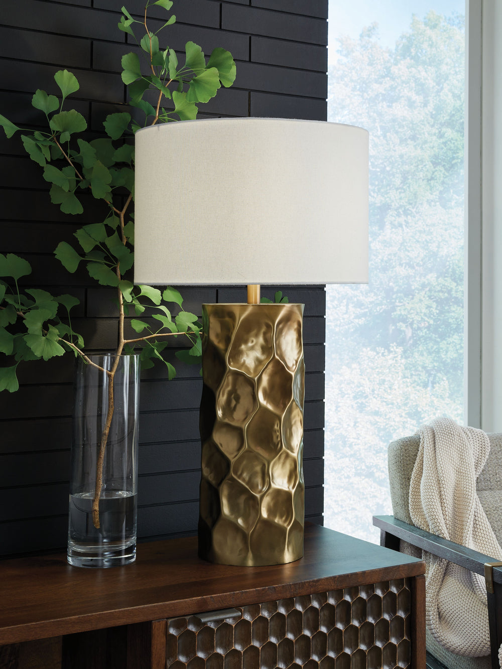 Make a bold metallic statement. Part functional lighting and part art form, this table lamp adds layers of dimension and visual interest to your space. A goldtone finish ups the glam appeal to complete the luxe take on contemporary design.<br><br><b>Addit