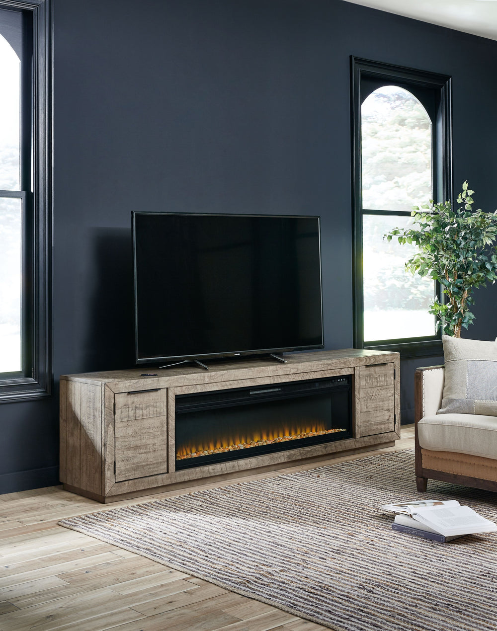 This extra-large TV stand with fireplace insert is sure to win your heart with its daring take on modern rustic expression. Its crisp, clean minimalist-chic profile is enriched with striking pine wood grain and a weathered gray finish with distressed saw 