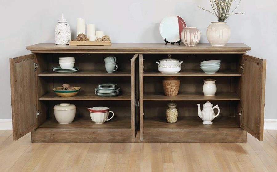 A four-door server is accentuated with antique mirror door fronts to create a rich, classic accent piece. Drawing the eye, this dining room addition is just the finishing touch you-'ve been searching for. Plentiful storage creates space for various types 