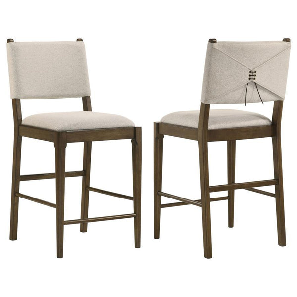 This counter-height dining chair combines modern design with elegant craftsmanship, making it a perfect addition to casual dining spaces. Upholstered in soft light tan fabric, it features foam-padded seating and a wrapped backrest with unique brown tie ac