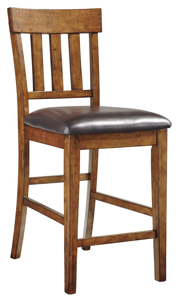 Sleek lines and comfortable cushioning combine to make this upholstered bar stool the favorite seat at the table. Traditional shaker design is given a vintage treatment with the rustic, burnished finish. Faux leather upholstery easily wipes clean.<br><br>