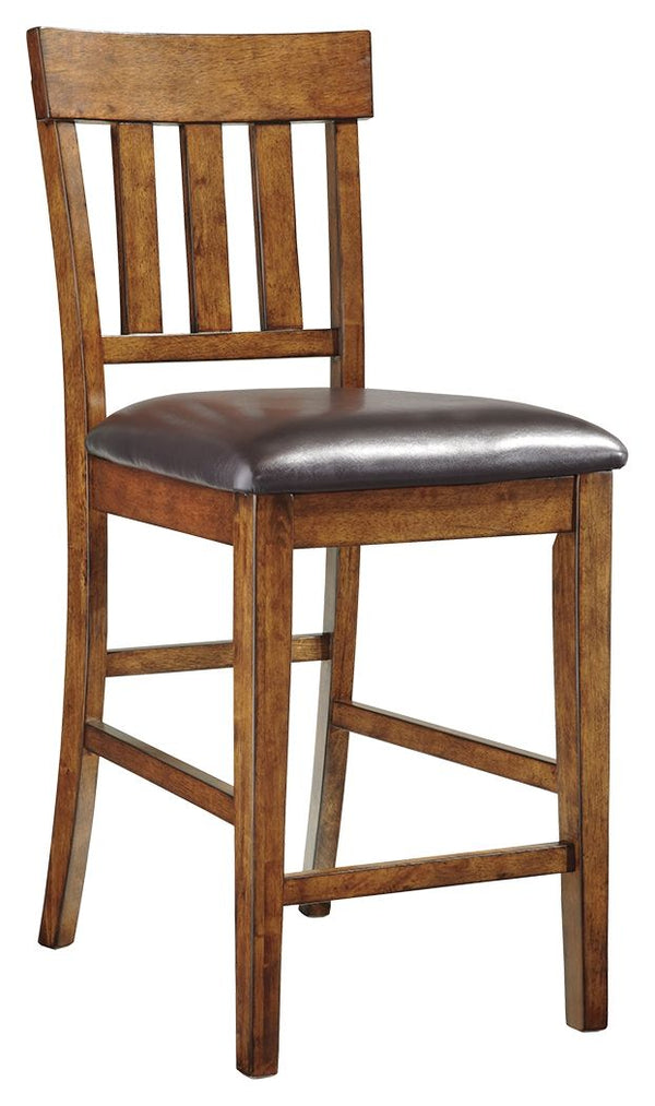 Sleek lines and comfortable cushioning combine to make this upholstered bar stool the favorite seat at the table. Traditional shaker design is given a vintage treatment with the rustic, burnished finish. Faux leather upholstery easily wipes clean.<br><br>