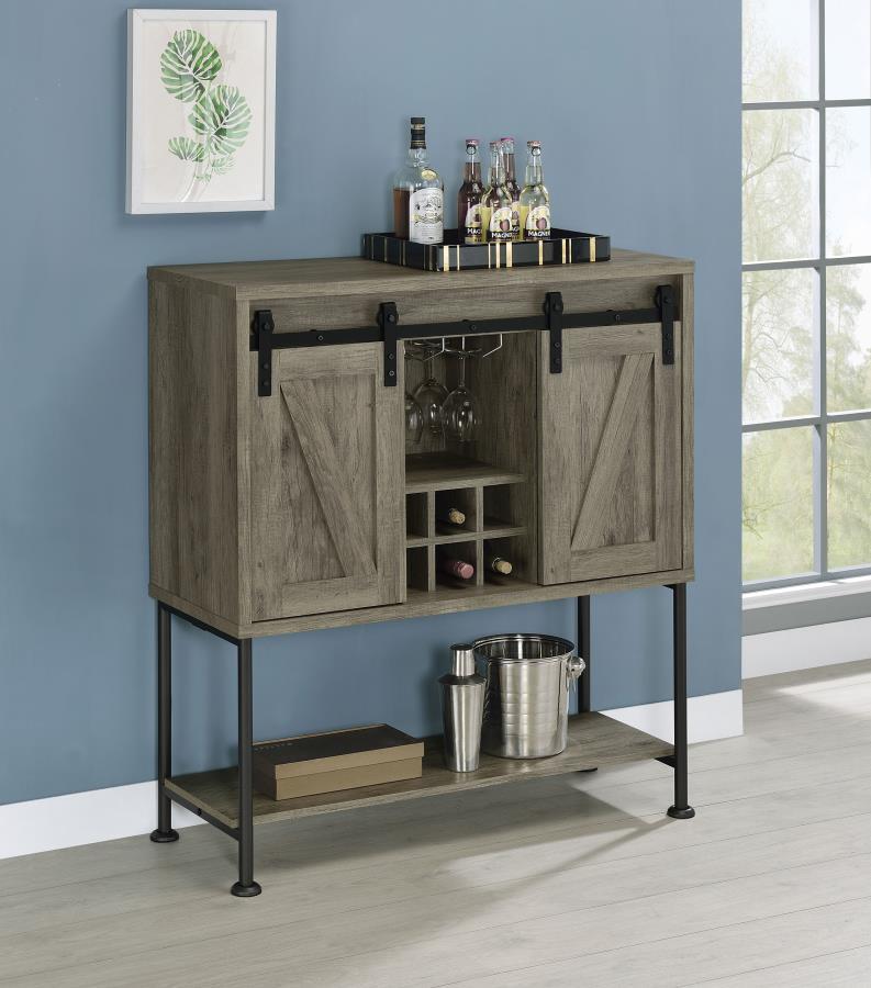 Perfect for a cottage or lakeside getaway, this bar cabinet features a light grey driftwood finish that is charming and cheerful. Place this bar cabinet in a rustic farmhouse home, as it offers country charm with two sliding barn doors that offer ample st