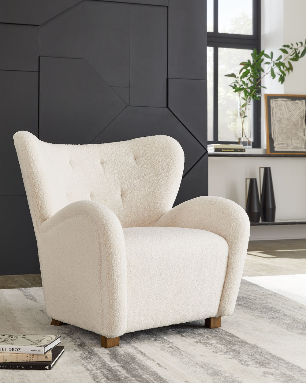 High style meets relaxation in this accent chair. Cozy faux shearling fabric keeps the look contemporary without compromising on comfort. A tufted wingback design and dramatic slope arms add high-fashion flair. It-'s the perfect place to curl up and enjoy