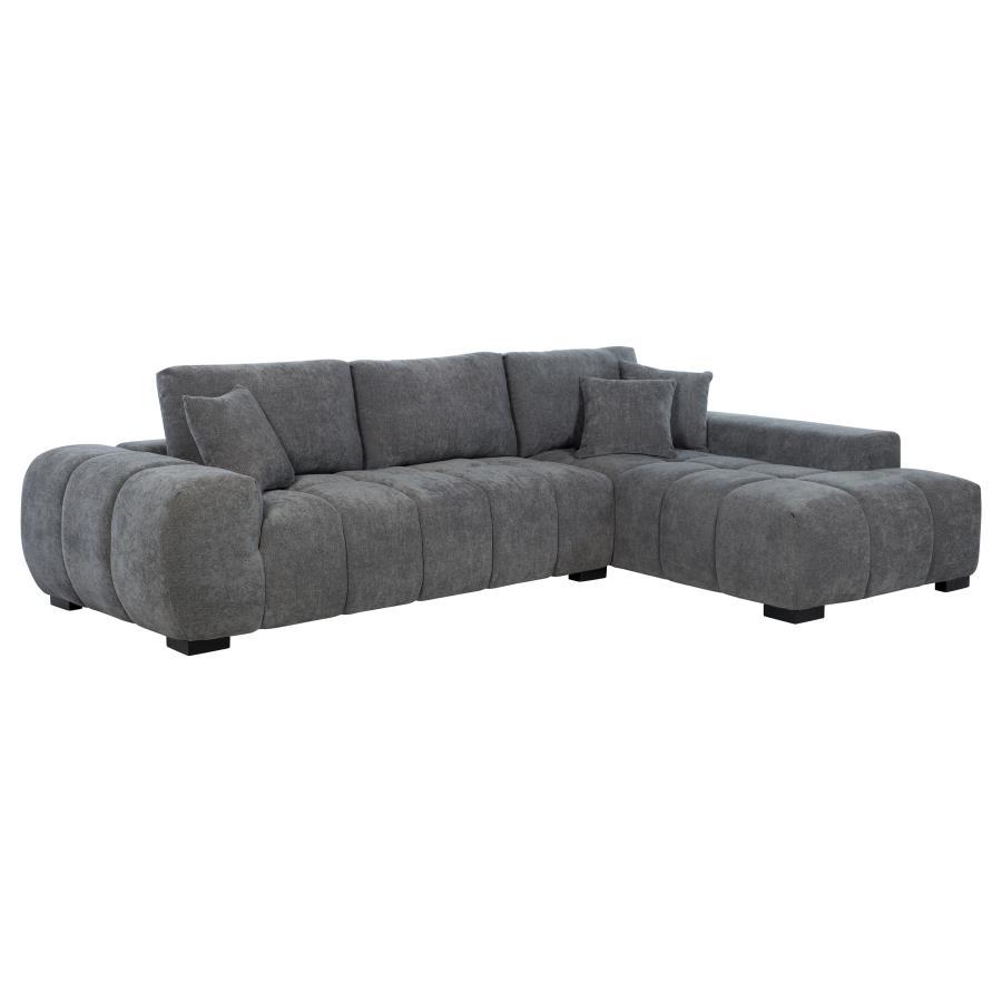 Embrace comfort and timeless style with this mid-century inspired sectional sofa. Designed for relaxed lounging, it showcases wide, rounded arms and plush waterfall seat cushions adorned with subtle grid tufting. Soft, neutral upholstery envelops a sturdy