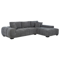 Embrace comfort and timeless style with this mid-century inspired sectional sofa. Designed for relaxed lounging, it showcases wide, rounded arms and plush waterfall seat cushions adorned with subtle grid tufting. Soft, neutral upholstery envelops a sturdy