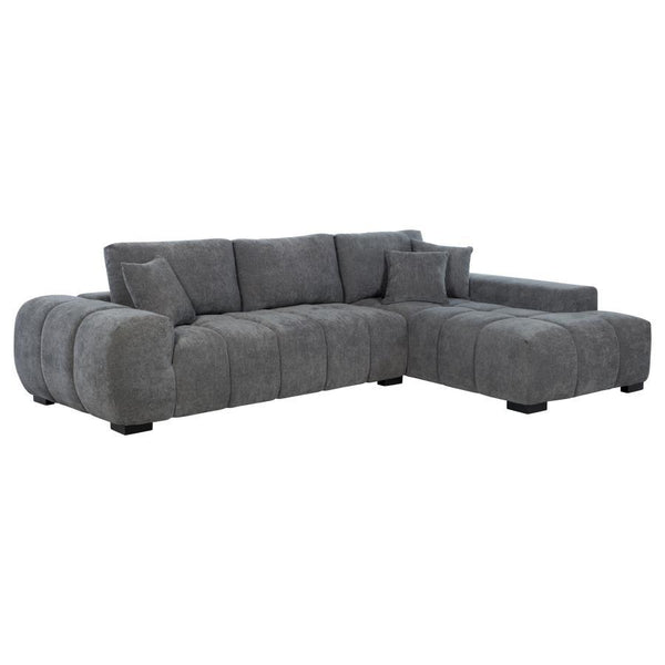 Embrace comfort and timeless style with this mid-century inspired sectional sofa. Designed for relaxed lounging, it showcases wide, rounded arms and plush waterfall seat cushions adorned with subtle grid tufting. Soft, neutral upholstery envelops a sturdy