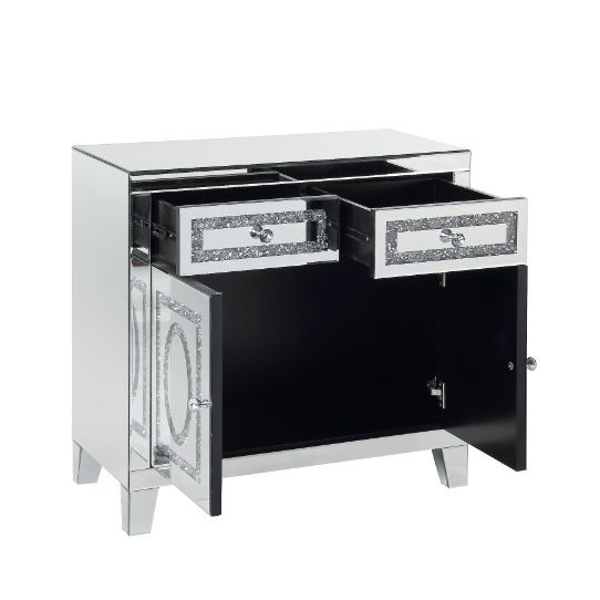 The modern glamour of the Noralie Mirrored Cabinet will brighten your foyer or bedroom. This brilliant cabinet features mirrored finish and faux diamond inlay, adding dimension, contrast, and shine to this functional piece. There are two doors and two dra