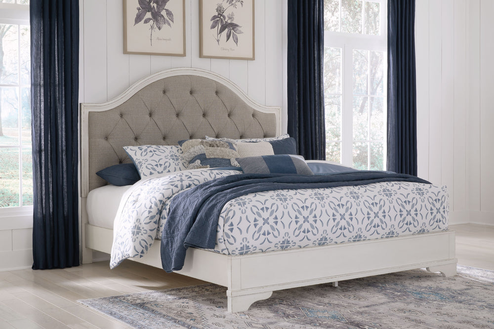 Traditional design. Casual appeal. You can have it all with this king upholstered panel bed. A relaxed chipped white finish and an inset headboard cushion with classic button tufting give the distinctive piece an allure all its own. And the low-profile si