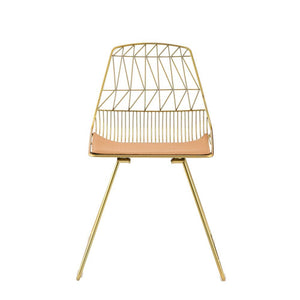 Modern elegance combined with contemporary design. This Fantasia side chair is stylish and durable. With its metal and faux leather craftsmanship, this piece will make a classy companion to any table. With its whiskey faux leather and gold finish, it will