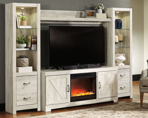 Express your farmhouse style with this entertainment center with fireplace insert. Its wispy white finish over replicated oak wood grain is a delightful change from the ordinary. Clean-lined, classic styling with barn door inspiration provides a country c