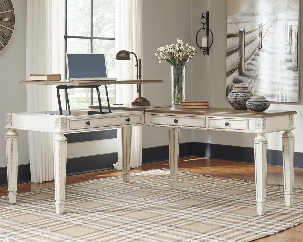 Elevating the art of traditional cottage styling, this L-shaped desk is your heavenly home office realized. Two-tone finish combines chipped white with distressed wood tone tops for added charm. Framed drawer fronts, decorative corbels and elegantly turne