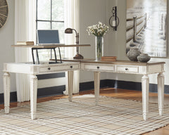 Elevating the art of traditional cottage styling, this L-shaped desk is your heavenly home office realized. Two-tone finish combines chipped white with distressed wood tone tops for added charm. Framed drawer fronts, decorative corbels and elegantly turne