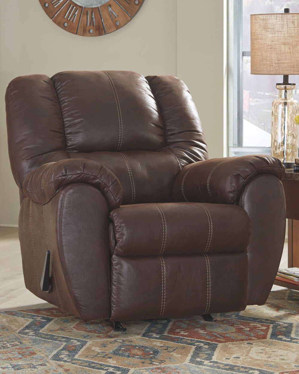 Rock the cool look of leather and the warm feel of fabric with this rocker recliner. Sporting sumptuously thick cushioning, fashion-forward jumbo stitching and a richly tailored aesthetic, this smartly priced recliner with gentle rocking motion is a bests