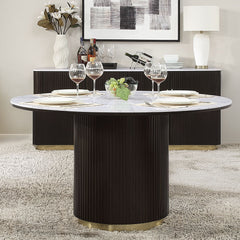 The Clayten collection features a round dining table with a fixed marble top, supported by a single pedestal base adorned with metal trim. Accompanied by upholstered chairs and a server with sleek metal legs, this set combines modern elegance with timeles