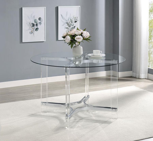  modern round dining table with sculptural appeal. It boasts four straight clear acrylic legs with four-point star bases that create incredible stability. The gleaming chrome finish stands out