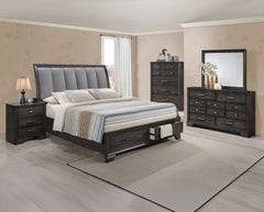 This bedroom set offers a sleek and stylish update to any space, featuring a rich, dark finish that commands attention while maintaining a sense of warmth and coziness. The bed stands as the stunning centerpiece, with its high, padded headboard upholstere