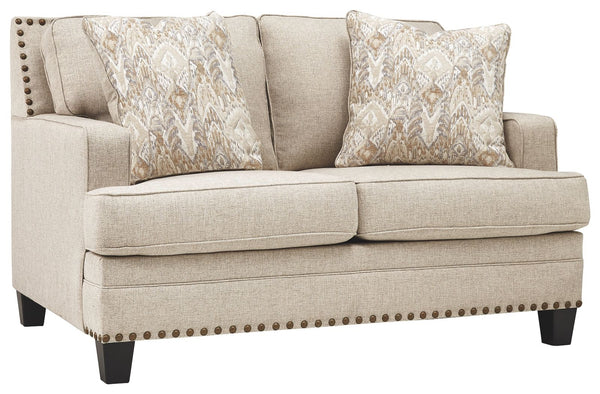 A case of contemporary and classic style influences coming together in a beautiful way, this loveseat in beige brings a fresh perspective to modern farmhouse living. Distinctive elements include t-cushions that wrap around setback track arms, nailhead tri