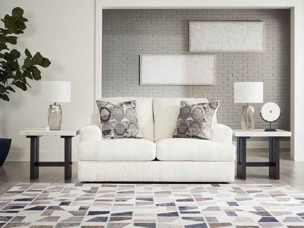 Craving casual refinement? This loveseat has you covered. Its decidedly contemporary frame cradles sizable cushions in an ultra-soft neutral hue, lightening the mood in your living room with simple style and everyday comfort. Solid and geometric accent pi