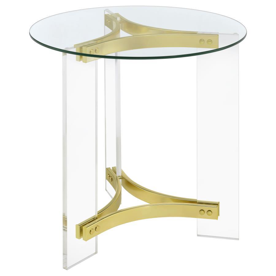 This elegant round end table features a clear tempered glass top and sturdy clear acrylic legs. The matte brass electroplated metal frame supports the piece with a touch of luxury. The minimalist design offers both style and function, making it a perfect 