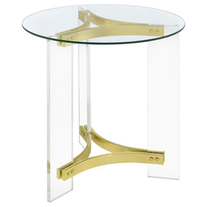 This elegant round end table features a clear tempered glass top and sturdy clear acrylic legs. The matte brass electroplated metal frame supports the piece with a touch of luxury. The minimalist design offers both style and function, making it a perfect 