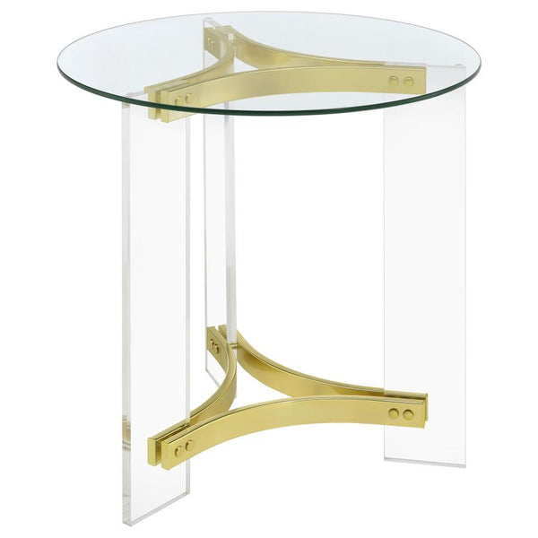 This elegant round end table features a clear tempered glass top and sturdy clear acrylic legs. The matte brass electroplated metal frame supports the piece with a touch of luxury. The minimalist design offers both style and function, making it a perfect 