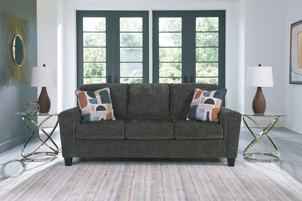 Thereâ€™s something about this sofa thatâ€™s so easy to appreciate. Maybe itâ€™s the plush upholstery and soothing tone, eager to support your quest for total relaxation. Perhaps it-'s the modern flair of its simple lines, tapered legs and abstract-patter