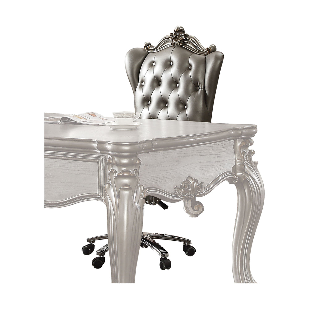 The Versailles executive arm chair classic style will blend masterfully in your home. Carefully constructed from faux leather, and selected veneers in rich antique platinum finish. Highly decorative details, button tufted backrest with Nailhead trim, and 