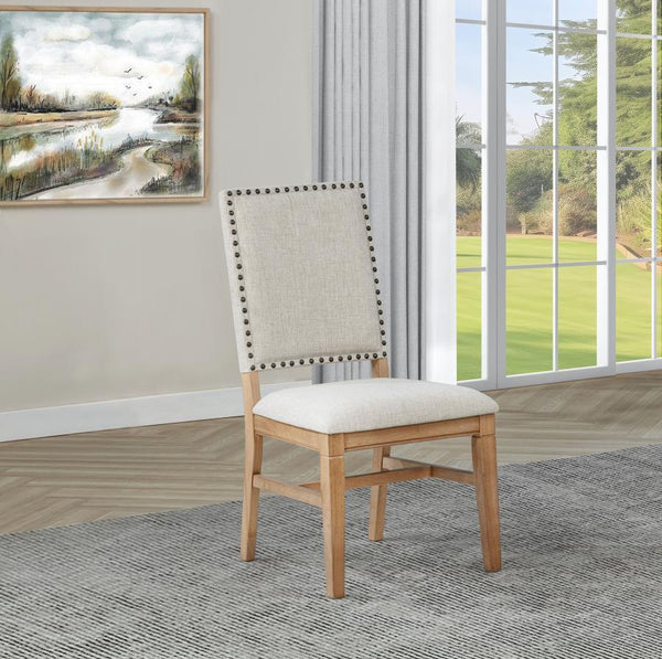  it features individually hand-driven black nailhead trim for artisanal detail. Crafted with a solid hardwood frame and legs in a natural bro
