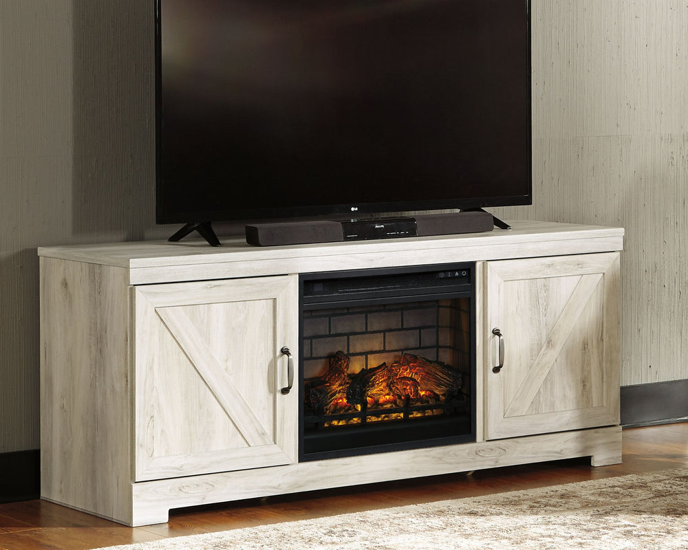 Express your farmhouse style with this TV stand with fireplace insert. Its wispy white finish over replicated oak wood grain is a delightful change from the ordinary. Clean-lined, classic styling with barn door inspiration provides a country chic aestheti