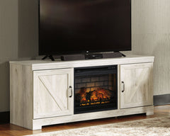 Express your farmhouse style with this TV stand with fireplace insert. Its wispy white finish over replicated oak wood grain is a delightful change from the ordinary. Clean-lined, classic styling with barn door inspiration provides a country chic aestheti