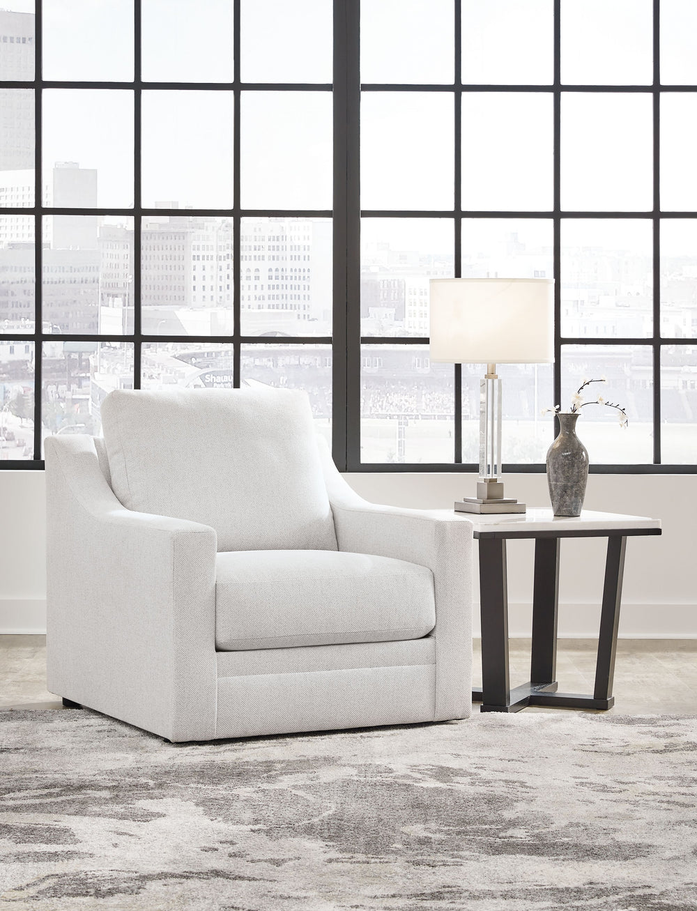 Clean lines and a streamlined silhouette define the architectural attitude of this accent chair. Soft, textured upholstery adds a luxurious high-end touch to the classic design. The chair-'s plush reversible seat cushion and pillowy back beckon you to sit